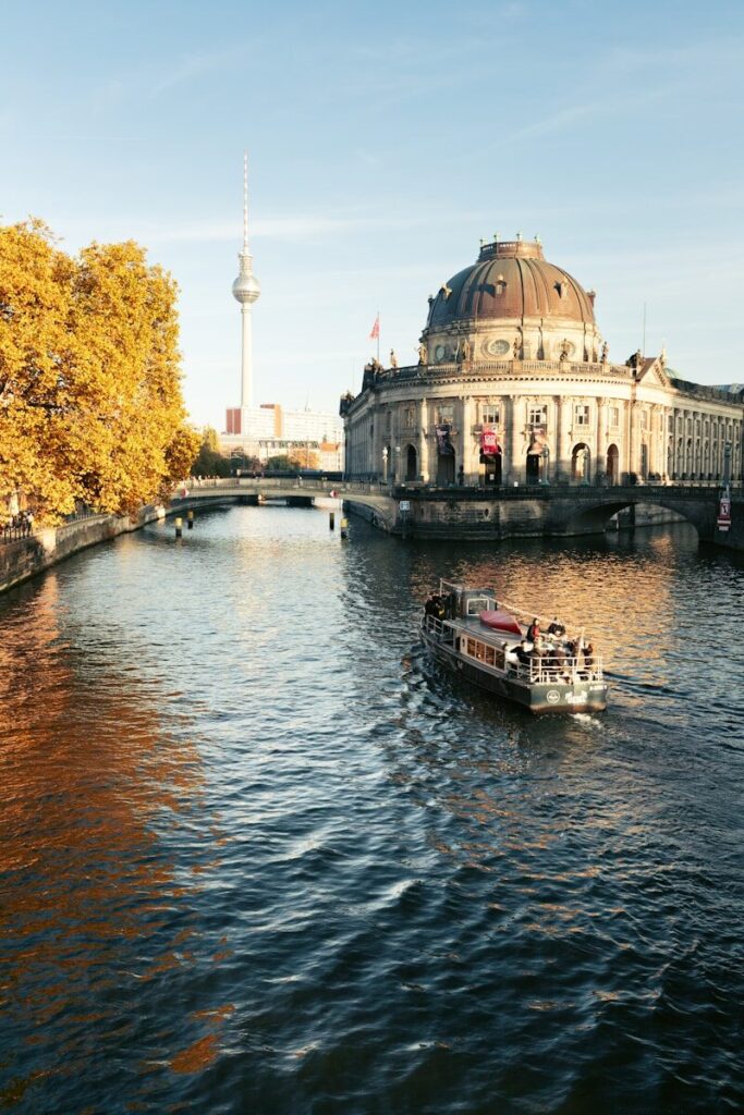 Boat on river with historic building and tower